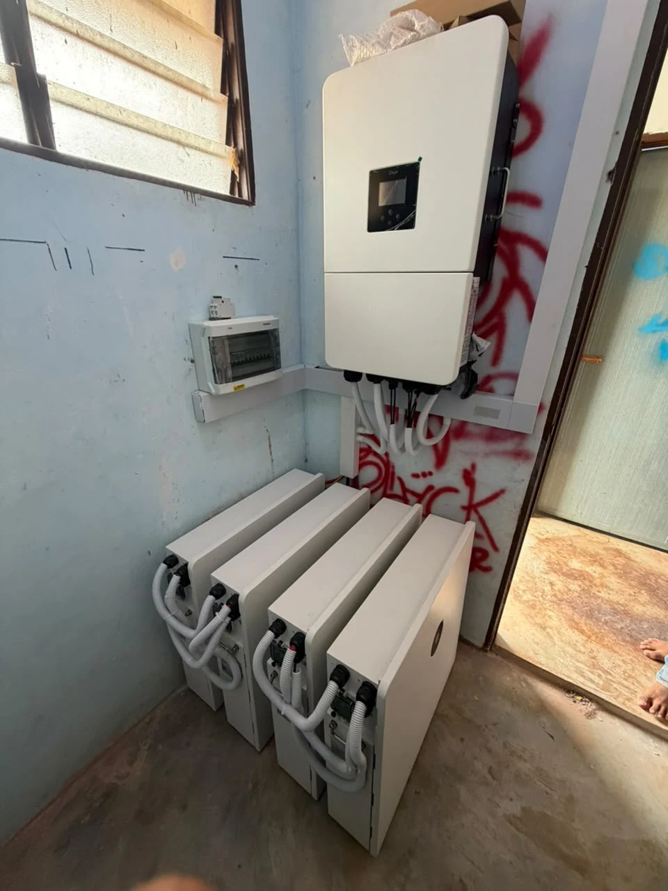 Inverter and four battery units at an off-grid solar installation in Pahang